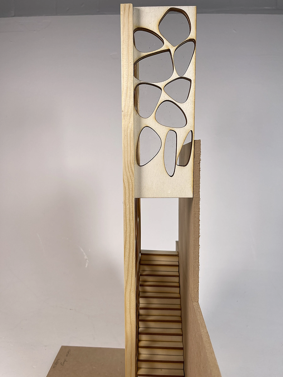 Staircase rising behind the screen