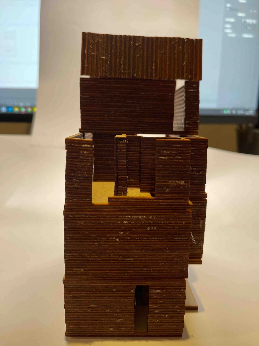 Sketch model, front: stacked laminated floors, roof lifted off