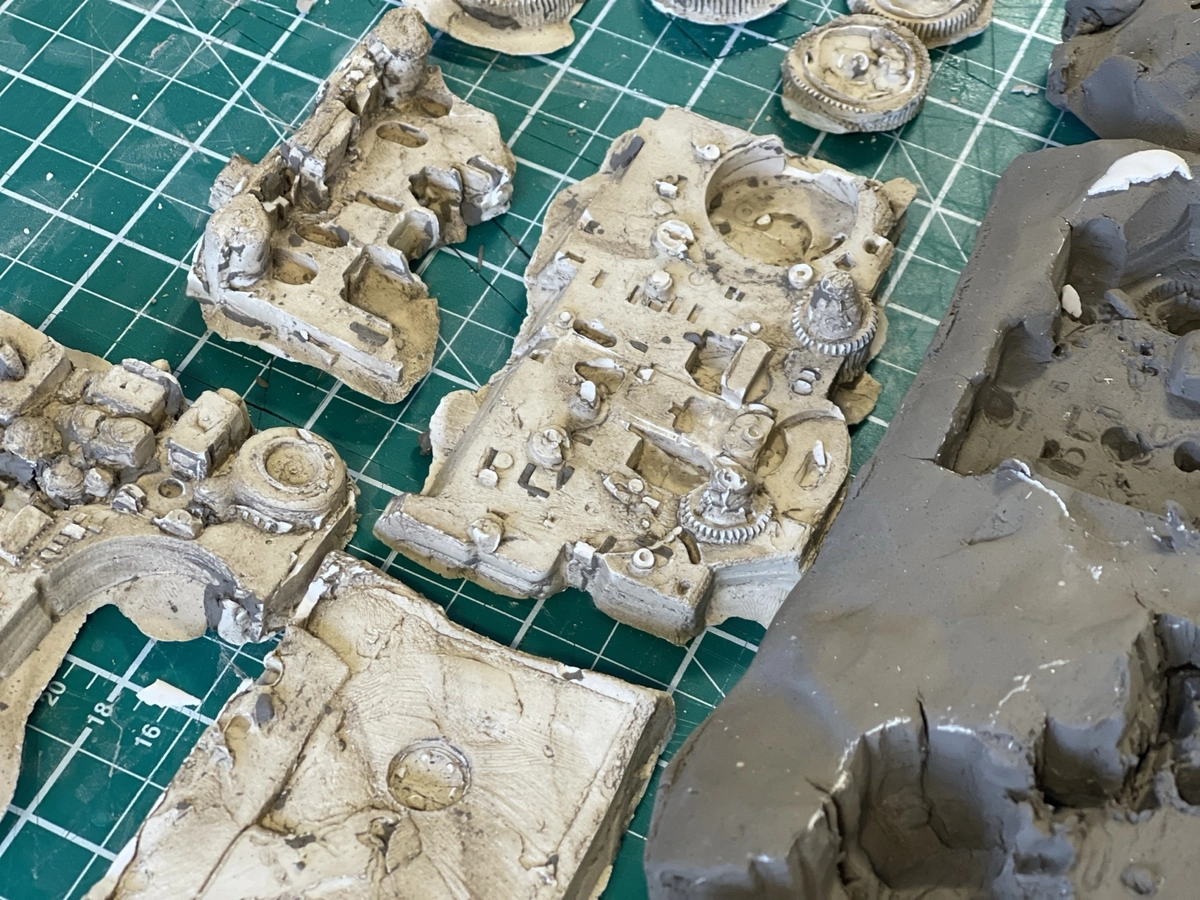 Cast detail: gears, boards and motor as impressions