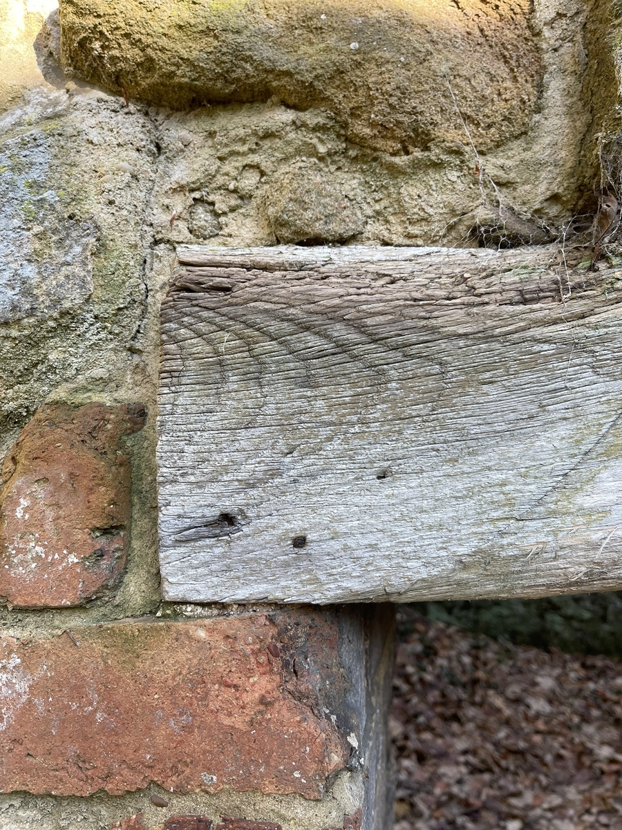 Timber lintel set into stone and brick